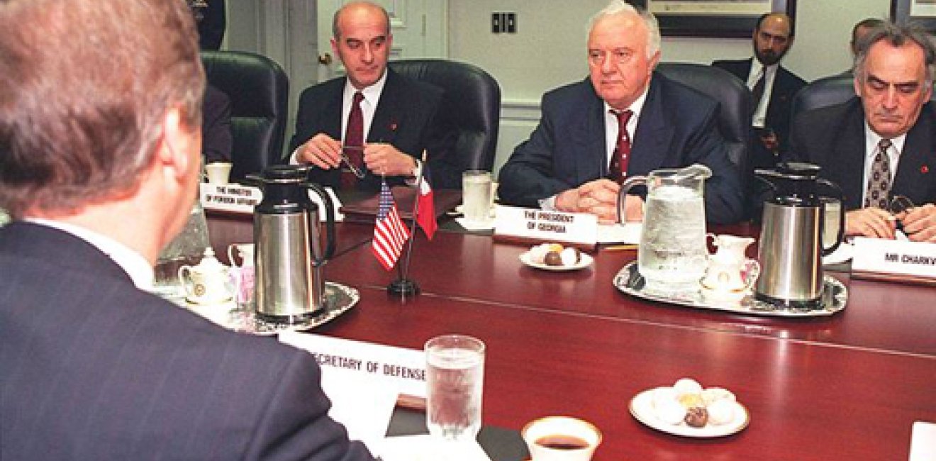 Secretary of Defense William S. Cohen (left, back to camera) meets with a delegation from Georgia led by President Eduard Shevardnadze (center), and including, among others, Minister of Foreign Affairs Irakli Menagarishvili (left, facing camera), and Mr. Charkviani, head of the Foreign Relations Department, serving here as interpreter (right). 