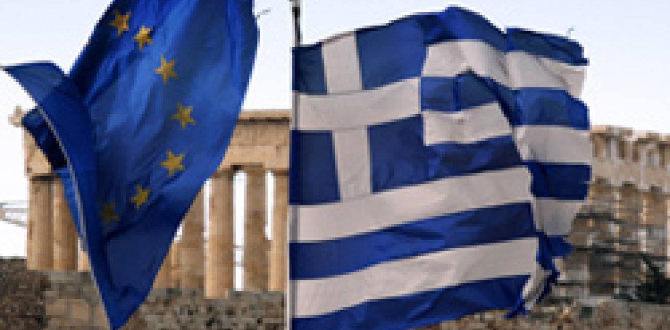 A Greek and an EU flag fly over the Greek ministry of finance in Athens