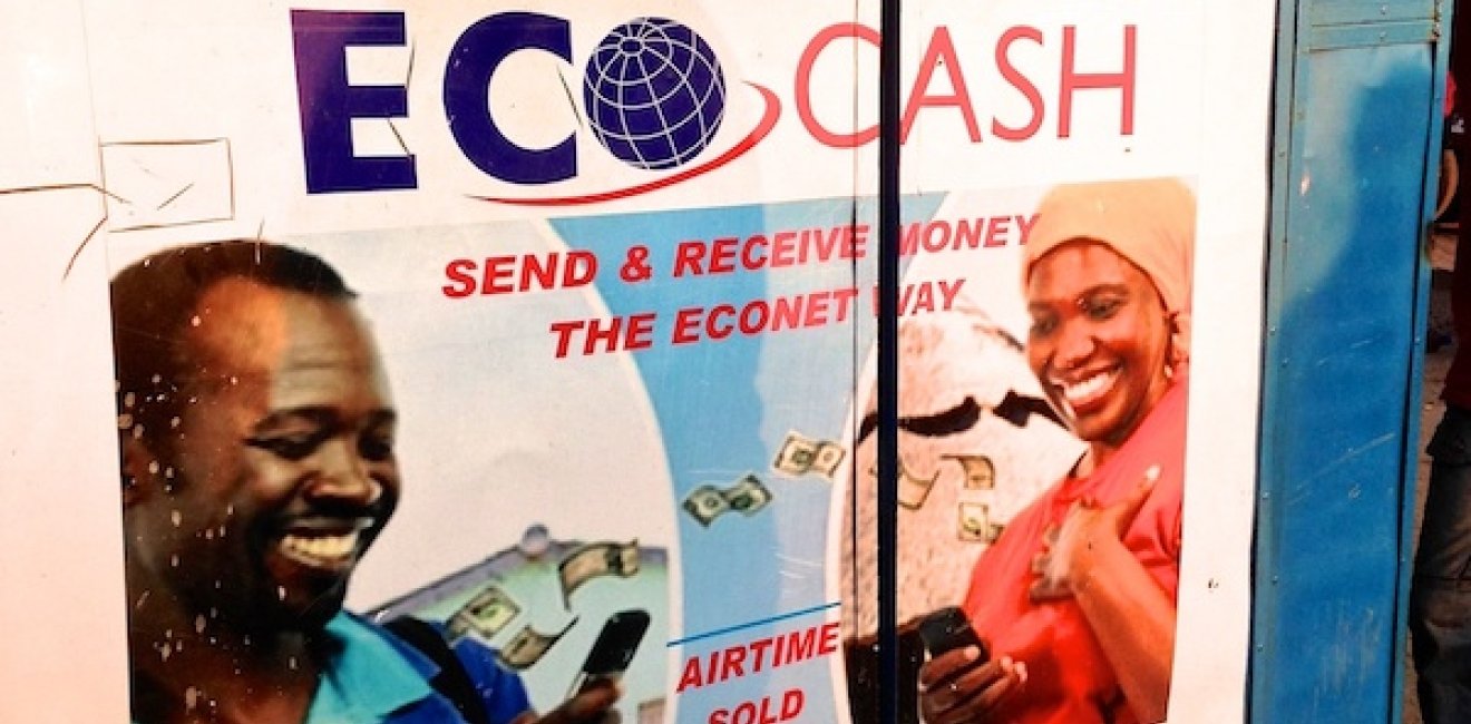 A stand selling phone credit in Zimbabwe, with ads for mobile money. Zimbabwe has shut down internet access in response to protests. Photo by Kay McGowan, USAID, via Flickr. Creative Commons.