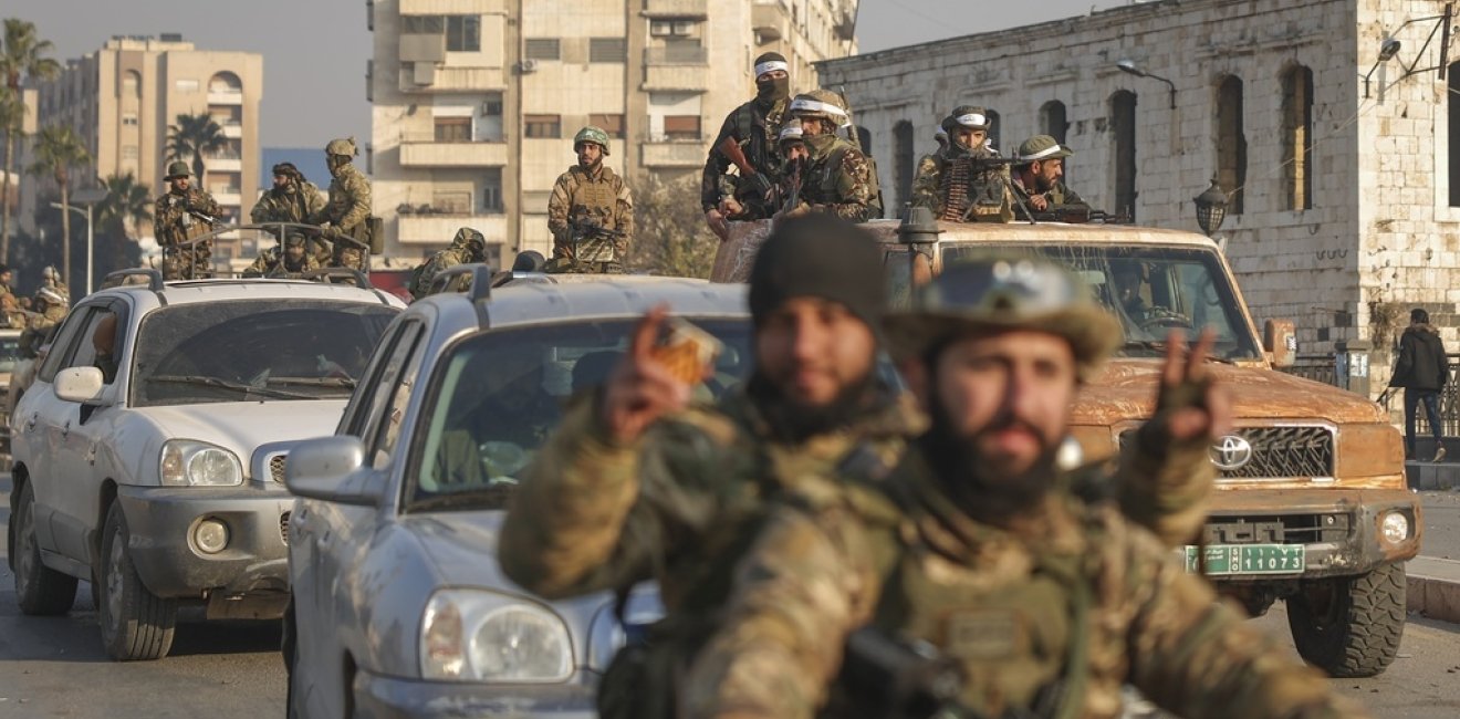 Syrian opposition fighters ride along the streets in the aftermath of the opposition's takeover of Hama, Syria, Friday, Dec. 6, 2024. 