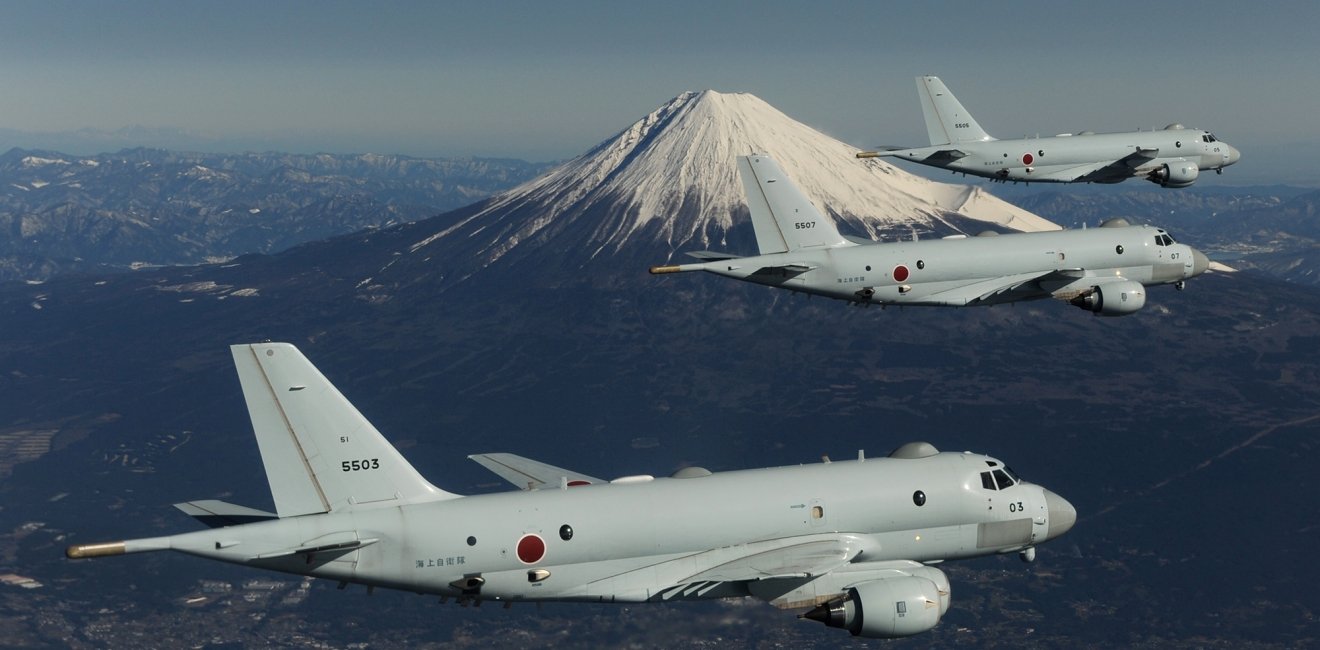 Three JMSDF planes in flight with Mount Fuji in the background.