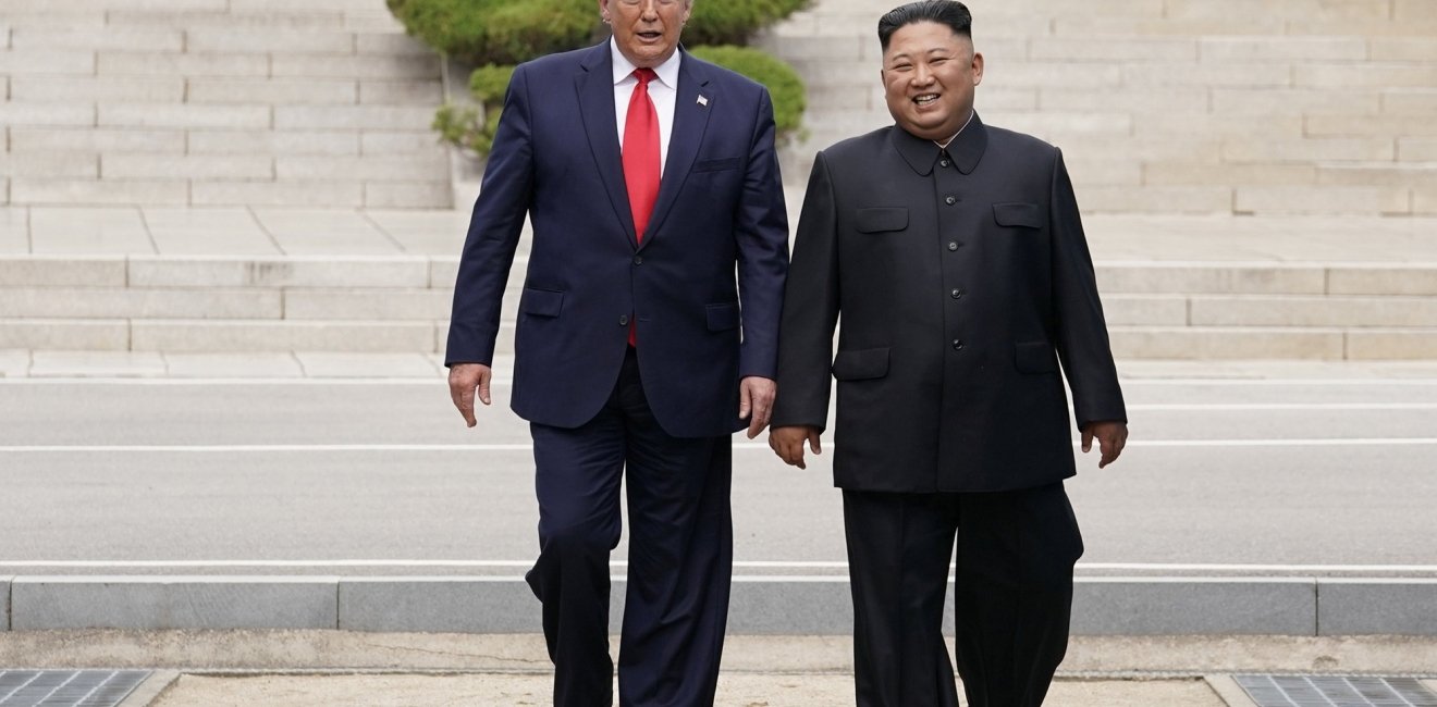 Donald Trump and Kim Jong Un walking together.