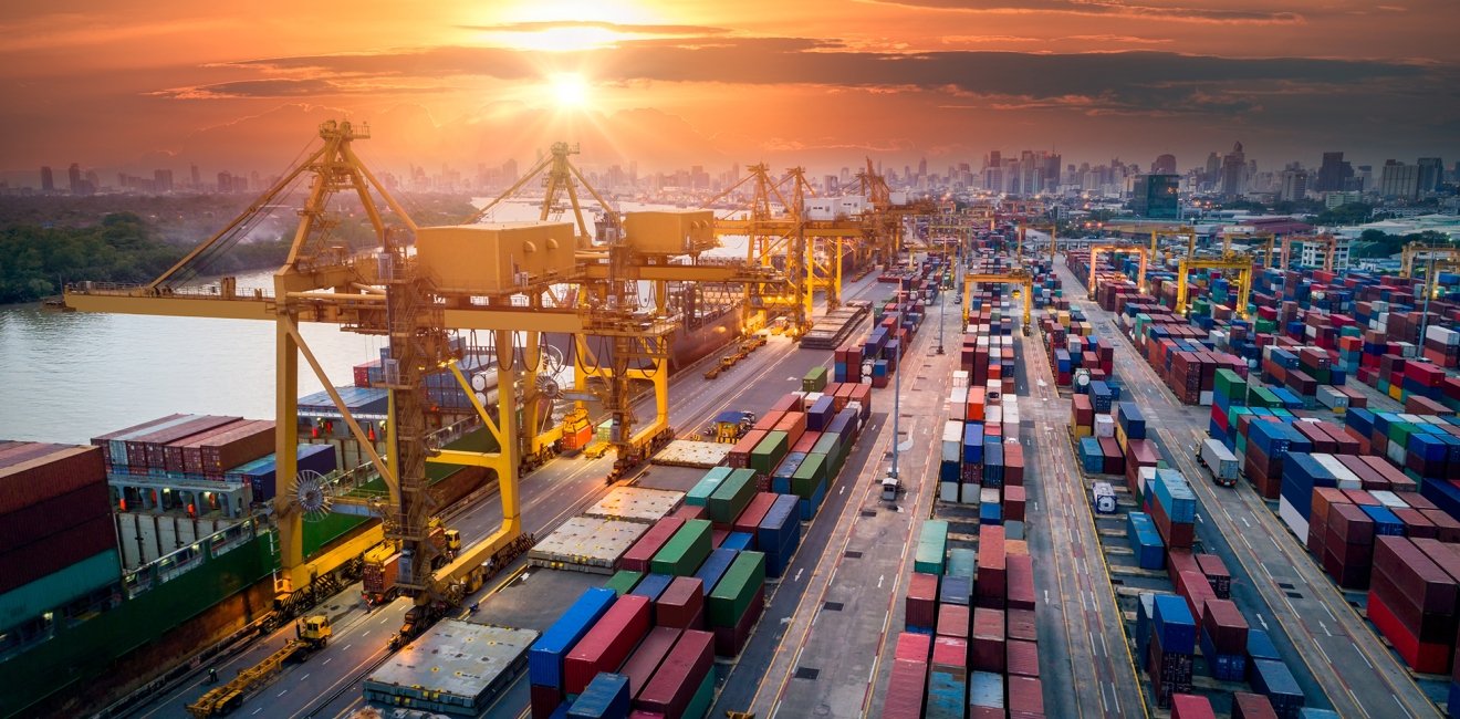 An image of a shipping port unloading containers.