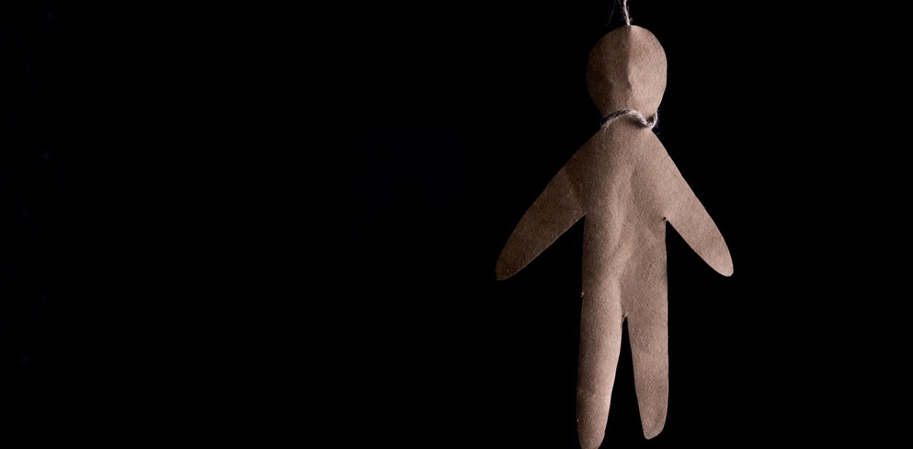 Paper doll hanging by a noose 