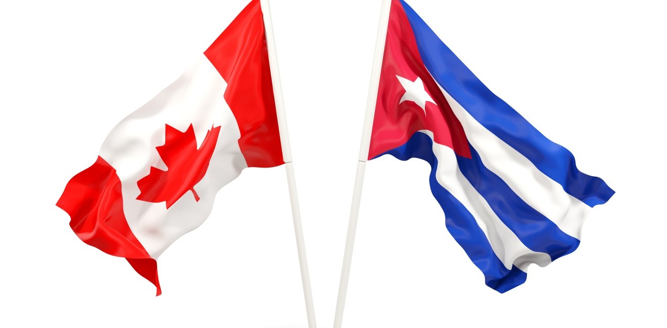 Two waving flags of Canada and cuba isolated on white