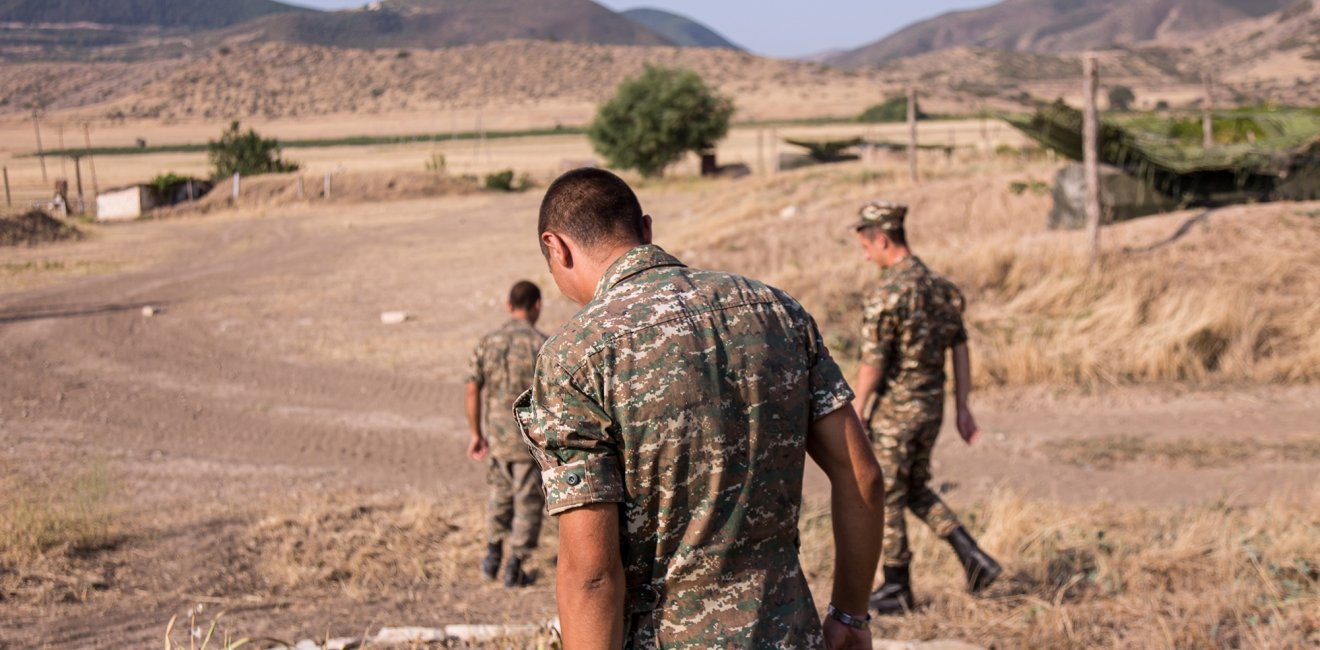 Nagorno-Karabakh, Republic of Artsakh - 08/03/2019 - Three soldiers of the Artsakh Defense Army walking on dirt road in their off time