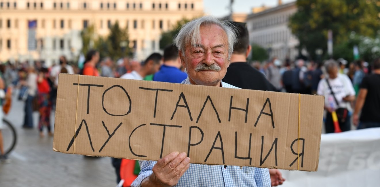 Man holding protest sign in Sofia, Bulgaria