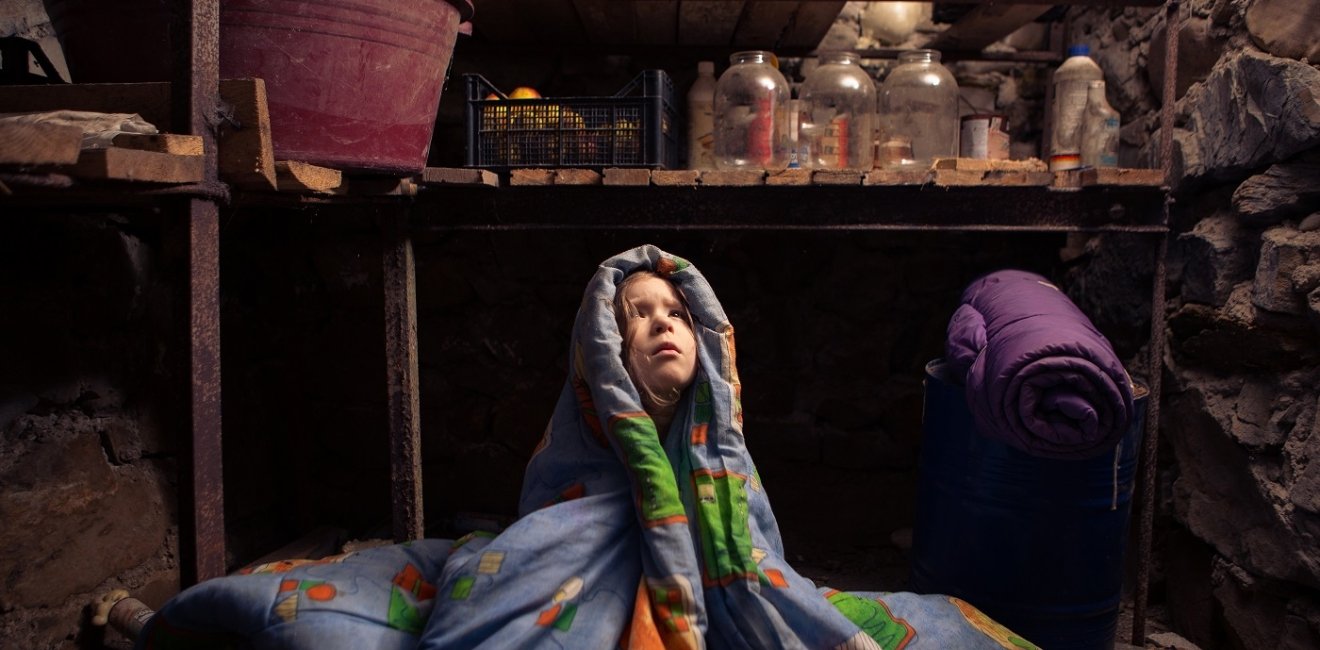 Ukrainian child takes shelter in her basement