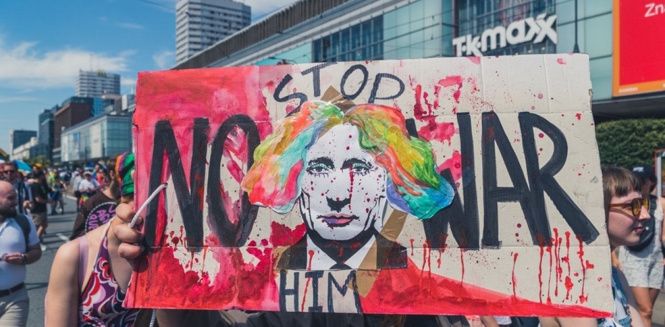 Sign at Polish protest depicting Putin as a clown with the caption "Stop Him--No War"