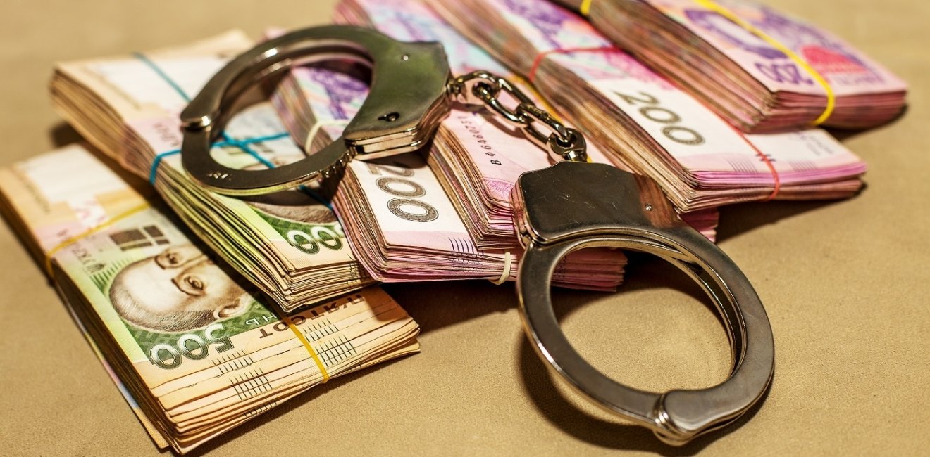 Iimage of Ukrainian hryvnia and handcuffs