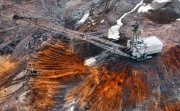 An excavator in a quarry extracting rare minerals.