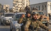 Syrian opposition fighters ride along the streets in the aftermath of the opposition's takeover of Hama, Syria, Friday, Dec. 6, 2024. 