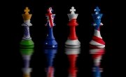 Four chess rooks with the flags of India, Australia, Japan, and the United States imprinted on them.