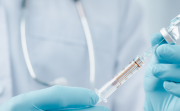 octor or scientist in laboratory holding a syringe with liquid vaccines for children or older adults