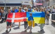 Marchers hold Ukrainian and Danish flags