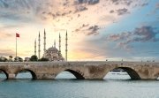 Sabanci Central Mosque and Stone bridge in Adana, Turkey, and the view of Seyhan river with sunset sky. Landmarks in the city of Adana, Turkey