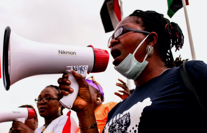 Women trying to make there voices heard using a megaphone