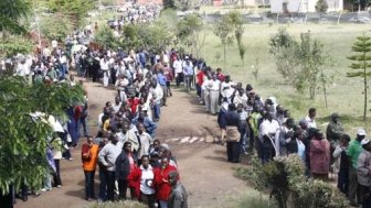 Voters queuing at a polling station in Kenya during the 2007 elections. Photo courtesy of User DEMOSH via Flickr Commons.