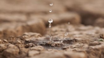 Water drop on dry cracked land