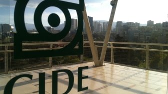 The CIDE logo on glass doors with Santa Fe in the distance