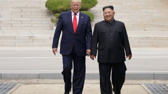 Donald Trump and Kim Jong Un walking together.