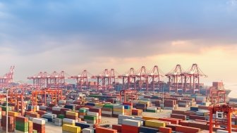 Image of the Shanghai port with shipping containers.