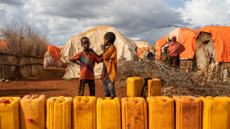 Children standing in line to fill water and yellow drums in Baidoa, Somalia, 2019.  Shutterstock