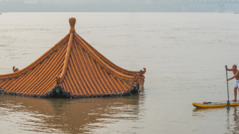 Man paddling on flooded Yangtze river in Wuhan, China.