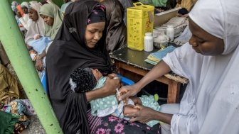 Rukayya Aboulkadia (right), a student health worker, is a routine immunization service provider administering the vaccinations.