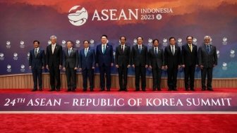 A group of ASEAN leaders stand in front of the logo for the 2023 ASEAN Summit.