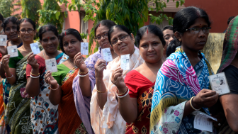 Indian women stand in queue with their Voter ID Card in hand during the West Bengal Three tier Panchayat Election approximate 40 k.m. from state capital Kolkata on May 14, 2018 in Hooghly, India.