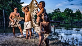 Members of the Boras Communidad, a Peruvian Indigenous group, with a jaguar skin from a cat they’d poached.