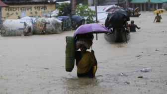 Women walking through flooded street, Bangladesh