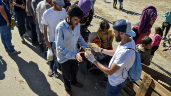 Refugees waiting in line for food.