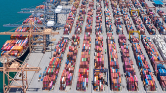 Aerial view of shipping container port with cranes