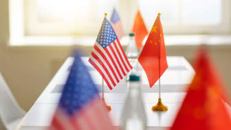 US and Chinese Flags Across a Table