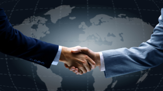 Handshake in front of world map