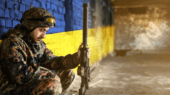 Soldier in front of Ukraine Flag