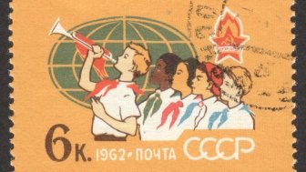  CIRCA NOVEMBER 2018: a post stamp printed in the USSR shows Pioneers of Different Peoples, Globe, the series "The 40th Anniversary of All-Union Lenin Pioneer Organization", circa 1962