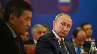 Russian President Vladimir Putin listen to president of Kyrgyzstan Sooronbay Jeenbekov during meeting of the Supreme Eurasian Economic Council in Yerevan, Armenia.