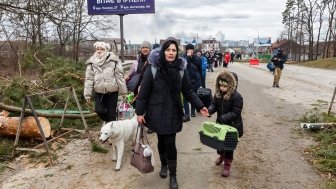 IRPIN, UKRAINE - Mar. 05, 2022: War in Ukraine. Women, old people and children evacuated from Irpin town was transferd to Kyiv by Kyiv territorial defense battalion. War refugees in Ukrain