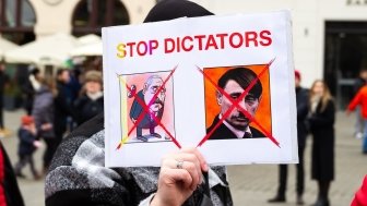 Protest poster with phrase "STOP DICTATORS" and satirical images of Putin and Lukashenko