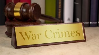 image of plaque reading "War Crimes" with gavel