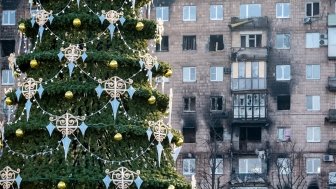 Christmas tree in front of ruined buildings in Ukraine