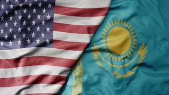 big waving flag of united states of america and national flag of kazakhstan