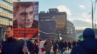 Moscow - February 27, 2016. Memory march of slain politician Boris Nemtsov. Demonstrator with a banner "He fought for free Russia" and portrait of Boris Nemtsov