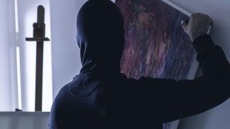 depiction of a thief stealing a painting