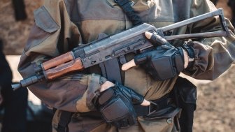 Man in Military Uniform Holding Weapon