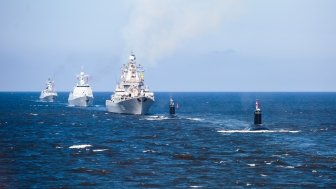 A line of modern russian military naval battleships warships in the row, northern fleet and baltic sea fleet in the open sea