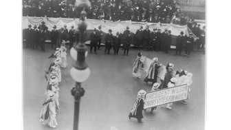 Suffragettes parading with banner "President Wilson favors votes for women". N.Y.C. , ca. 1916. Photograph. https://www.loc.gov/item/2001704196/.